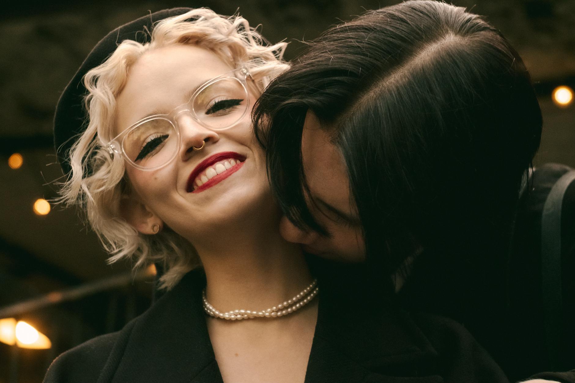 A joyful couple shares a loving embrace outdoors, highlighting happiness and affection.