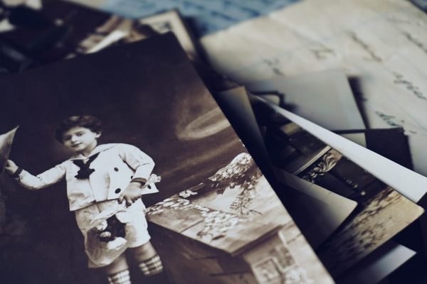 A nostalgic close-up of vintage photos and letters revealing memories from the past.