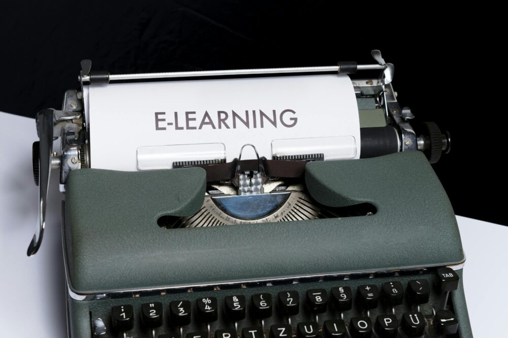 Close-up of a vintage typewriter displaying the concept of e-learning on paper