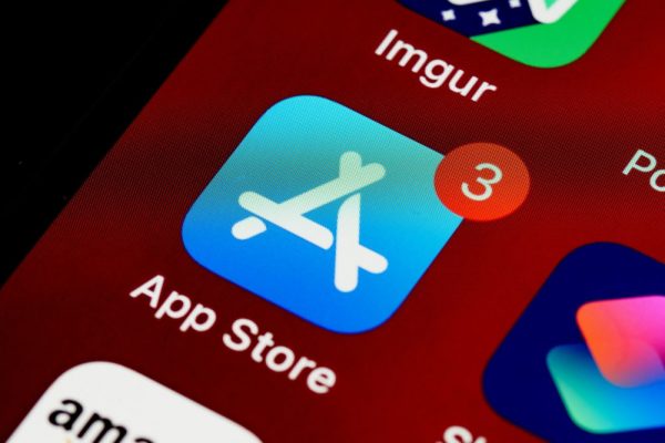 Close-up of App Store icon on iPhone screen with notification badge, highlighting app updates.