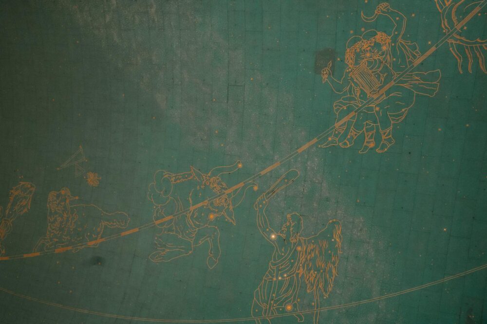 Illustration of zodiac signs on a historic astronomical ceiling, showcasing intricate details and vintage charm.