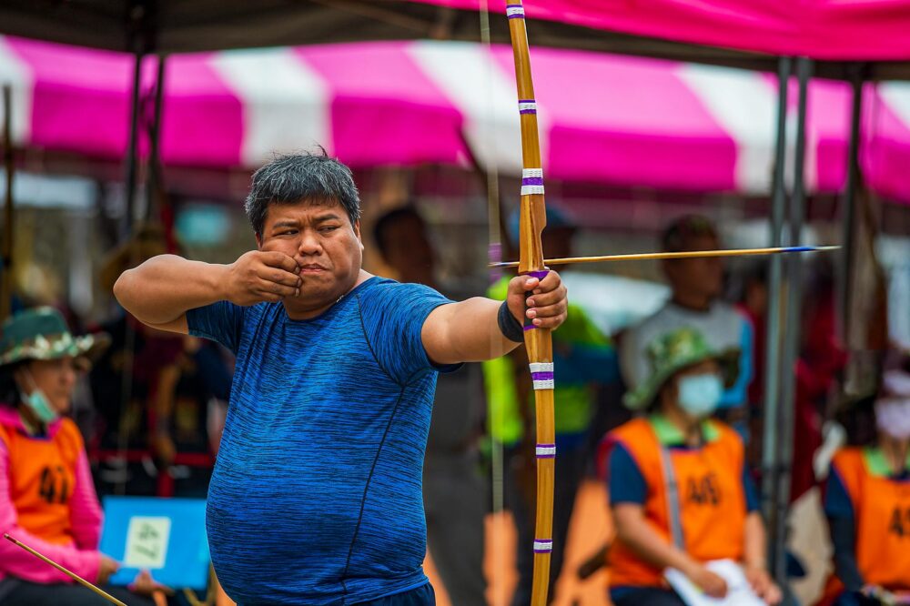 An East Asian man participates in a traditional archery competition in Taitung, Taiwan.