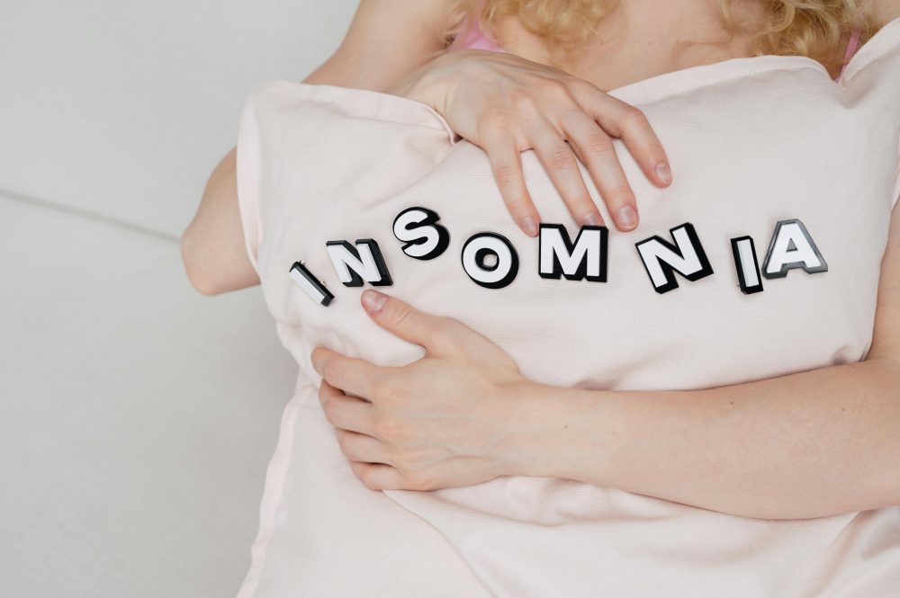 Close-up of a woman holding a pillow with