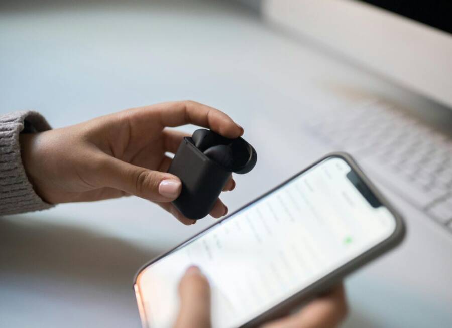image of wireless earbuds connected to smartphone