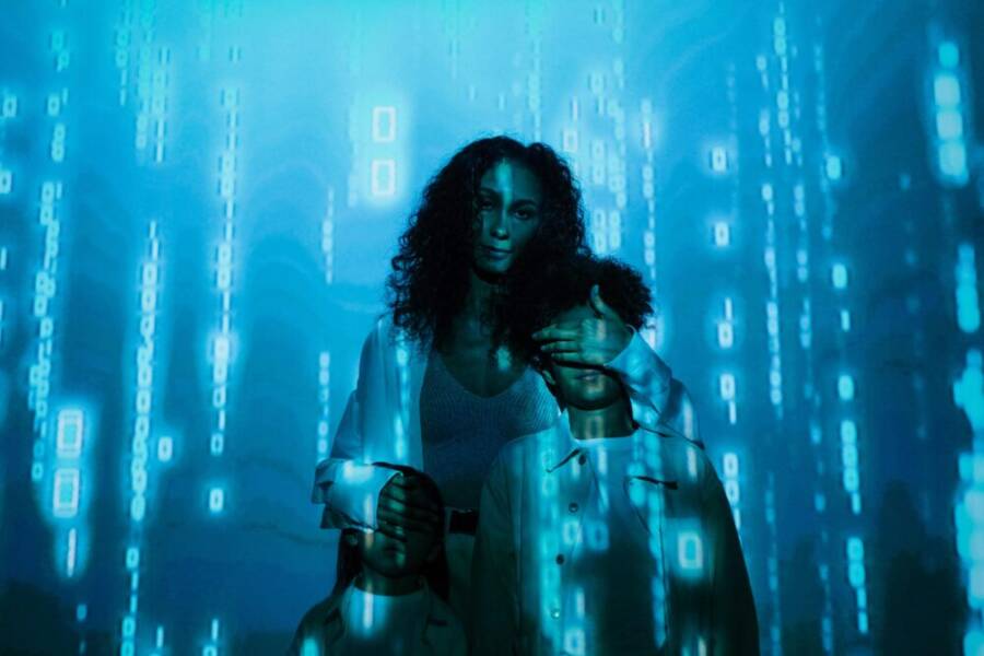 A family stands in digital blue light, symbolizing online privacy and security.