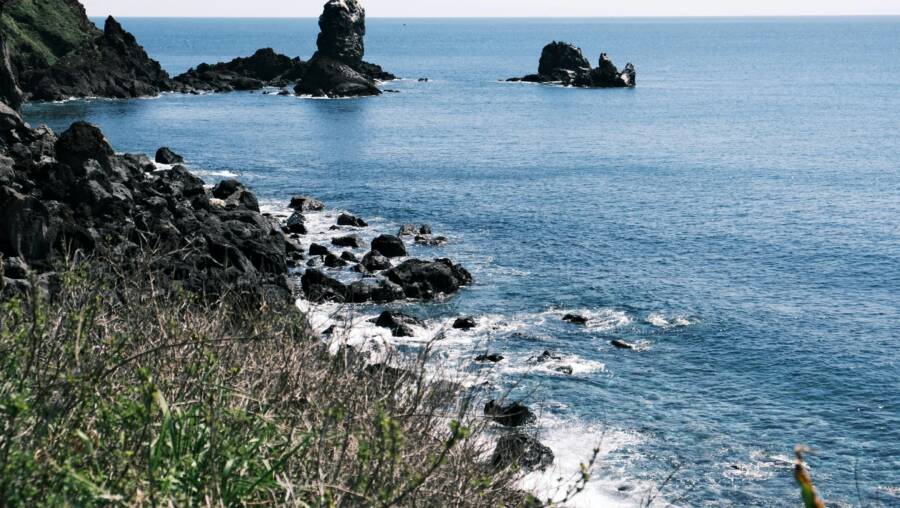 探索濟州島岩石海岸線的崎嶇之美，這裡有淡水藍的海水和自然形成的奇觀。